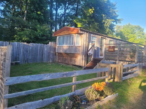 Three-bedroom wooden cabin at Postwood Gardens Campsite in Kentisbeare with garden view, wooden fencing and flower beds