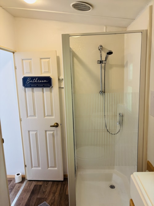 Modern bathroom with walk-in shower at Postwood Gardens Campsite, Kentisbeare