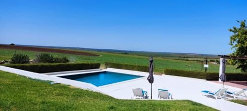 Modern pool overlooking rolling countryside at Monte da Morena Agro Turismo in Serpa, Portugal