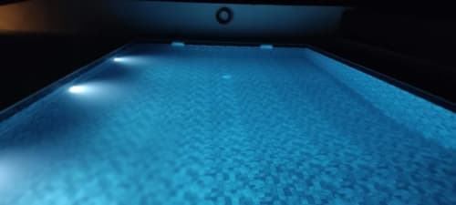 Illuminated swimming pool at Monte da Morena Agro Turismo in Serpa, Portugal, evening lighting on blue water
