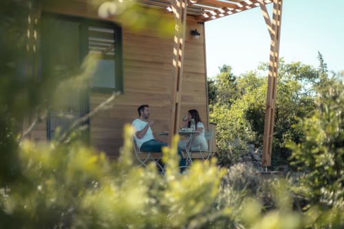 Couple relaxing on pergola terrace at Pépiite BnB in Villeneuve, Ardèche gorges with mountain views