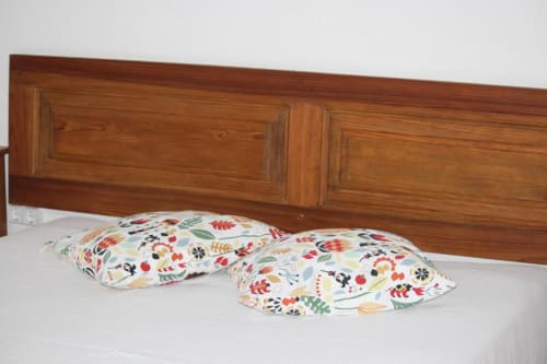 Colorful patterned pillows on a bed with wooden headboard in Superior Double Room at Monte Da Morena, Serpa