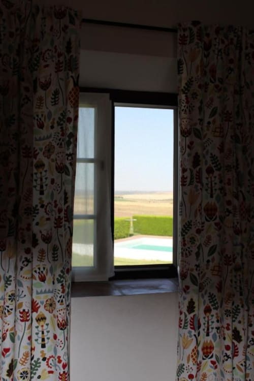 Garden view from Superior Double Room at Monte Da Morena Agro-Turismo, showing pool and countryside landscape through open