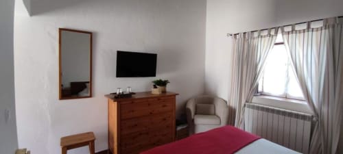 Standard double room at Monte Da Morena with wooden dresser, flat-screen TV, mirror, armchair and window with garden view