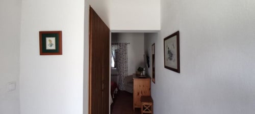 Double room hallway at Monte Da Morena Agro-Turismo in Serpa with wooden door and framed artwork