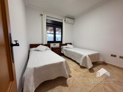 Habitación doble en Barrosa Home Villa Cañuela con dos camas, aire acondicionado y vistas por ventana