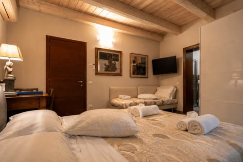 Ampia camera tripla in Al Battistero Luxury Suite a Ravenna con letti gemelli, TV schermo piatto e travi in legno