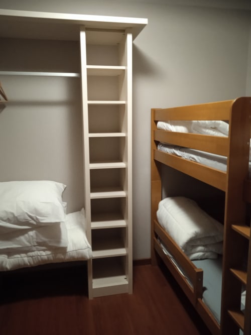 Chambre familiale avec lits superposés et rangements blancs aux Balcons du Sancy, Picherande