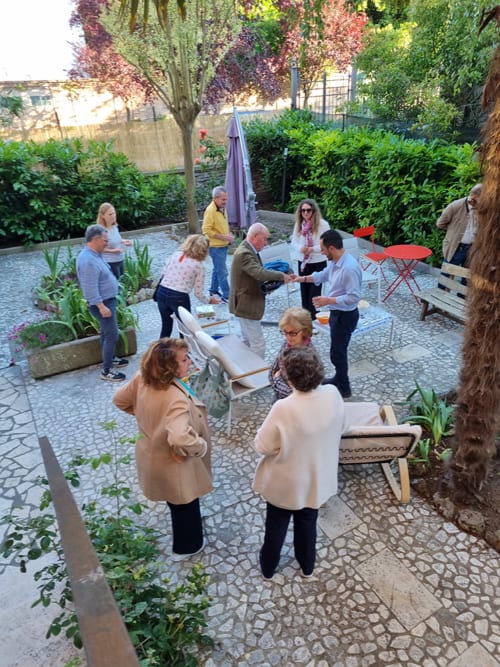 Guests enjoying aperitivo in the courtyard garden at Cristallo Apartment, Ravenna