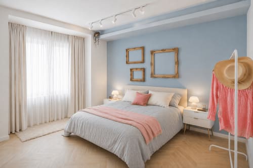 Modern bedroom at Colosseum Exclusive Stay Rome with light blue walls, queen bed, bedside tables, ornate frames, and full