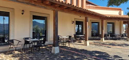 Hotel Atalaya terrace in Guadalupe with outdoor seating, mountains view, and Spanish architecture