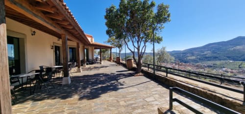 Hotel Atalaya terrace in Guadalupe with mountain valley views, furnished patio, and countryside landscape