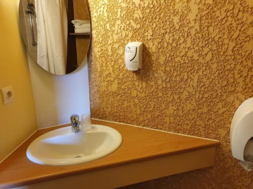 Modern bathroom sink and vanity in Libre Hôtel double room with mirror and soap dispenser