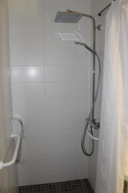 Modern shower enclosure with rainfall showerhead and handheld spray at Libre Hôtel, La Vespière
