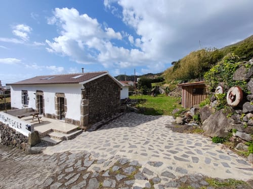 Casa Azorina villa at Casas Florescer in Fajazinha with mountain views, stone patio, and traditional Azorean architecture