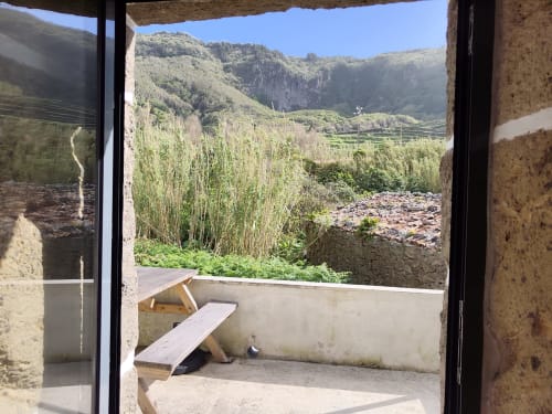 Terrace view from Casa Azorina villa at Casas Florescer, Fajazinha, overlooking mountain valley and lush vegetation