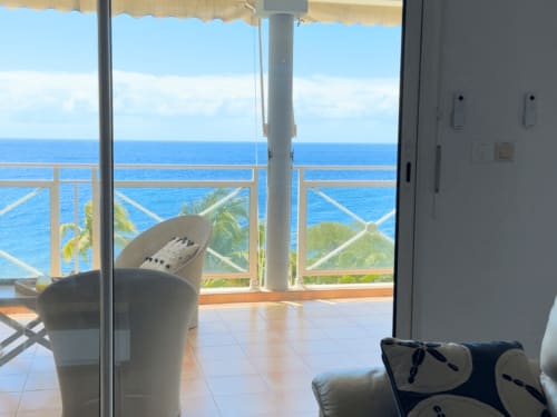 Horizon Doré balcony overlooking Caribbean Sea, Gourbeyre with ocean view and coastal furniture