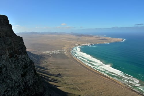 Aerial view of Tahiche coastline with golden beaches, turquoise waves, and volcanic landscape near Villa Estrella Polar
