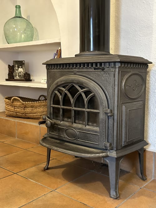 Cast iron wood stove in rustic room at Casa Gallinera vacation home, Alicante