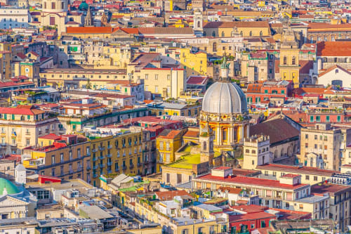 Colorful Naples cityscape with dome cathedral, vibrant buildings - Neapolis Tecnotourist view