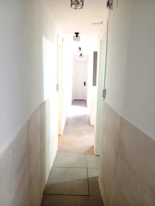 Bright hallway in Neapolis Tecnotourist BnB with tile flooring, white walls, and doors leading to rooms