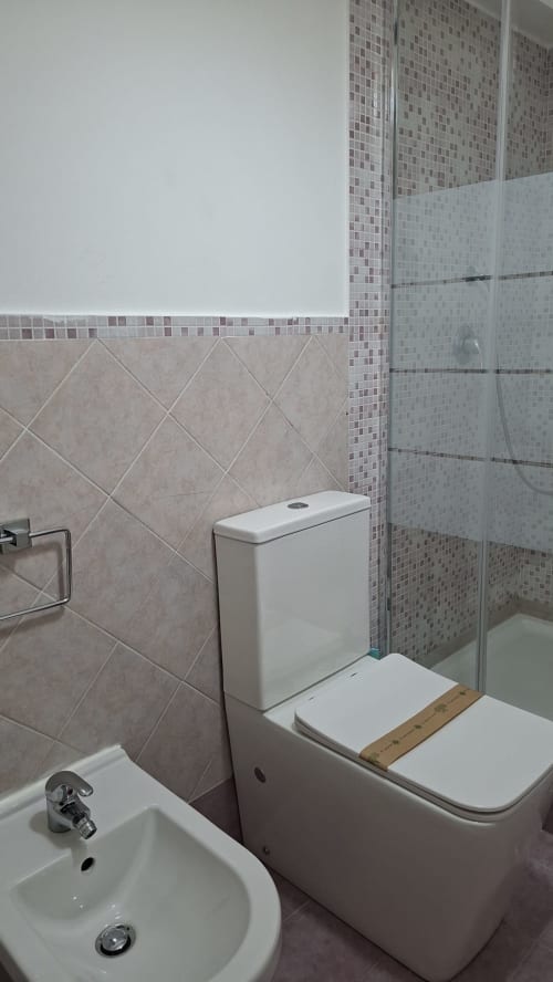 Bagno moderno nella suite Cleopatra dell'hotel Gold Leaf Sicily a Taormina, con WC, lavabo e cabina doccia in vetro
