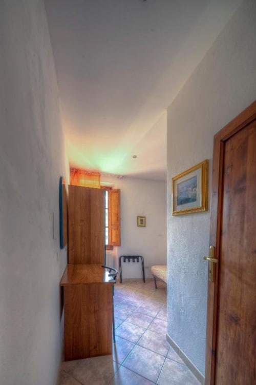 Corridoio della Guest House Sogni D'Oro a Firenze con porte in legno, lucernario luminoso e pavimento in piastrelle