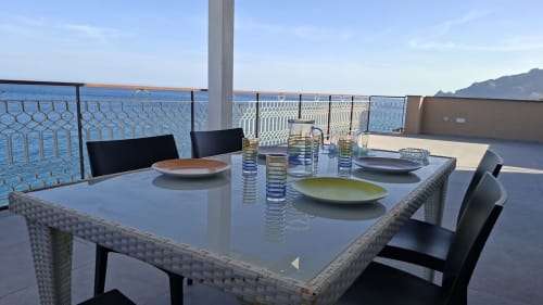 Tavolo sulla terrazza fronte mare dell'appartamento Cleopatra di Gold Leaf Sicily a Taormina con vista sul mare