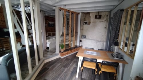 Modern studio interior at Les Troglos de Beaulieu with wooden desk, dining area, and garden view doors