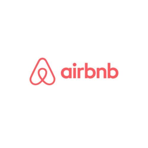 Logo de Airbnb con icono de chincheta roja de ubicación y marca de texto