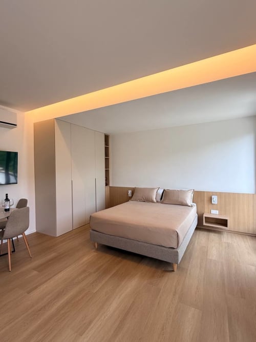 Modern bedroom at Adagio Ravello Ravello with queen bed, wooden flooring, mountain views, and contemporary furnishings