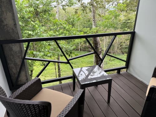 Balcón de villa moderna en Contenedores Boutique Hotel con vistas al exuberante jardín y bosque de Costa Rica