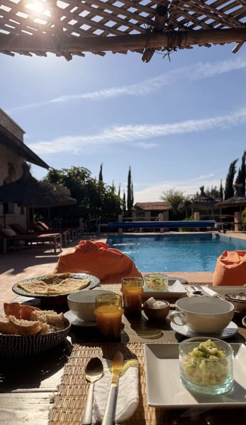Breakfast table overlooking pool at Maison la Chèvre boutique hotel in Essaouira, Morocco