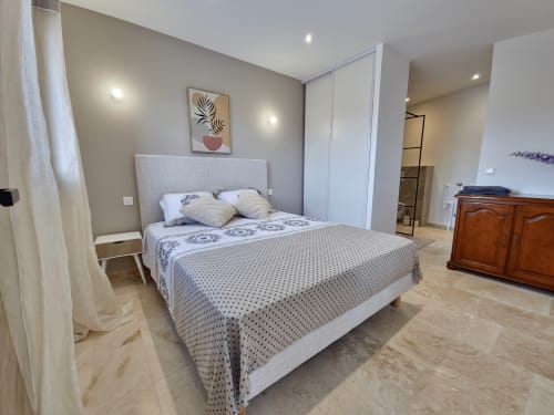 Modern bedroom at Smooth Luberon in Villars with queen bed, built-in wardrobes, and mountain views