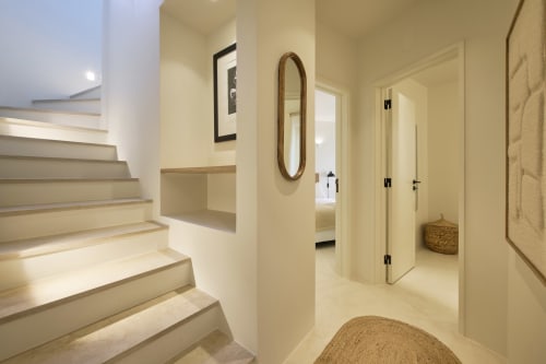 Modern hallway with stairs and wooden mirror in Casa Redonda apartment, Aroeira Portugal