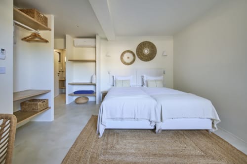 Studio bedroom at Casa Redonda by Villas Aura in Aroeira with twin beds, woven décor, and garden view