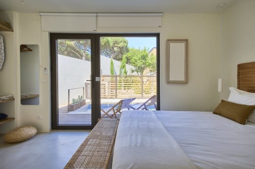 Modern bedroom at Casa Redonda with pool view, terrace access, and garden outlook in Aroeira