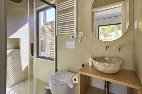 Modern bathroom with stone sink and shower at Casa Redonda villa in Aroeira, Portugal