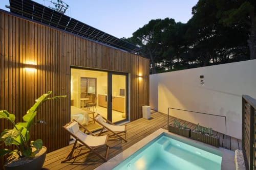 Casa Redonda 5 apartment at Casa Redonda by Villas Aura in Aroeira with illuminated wooden deck, lounge chairs, and private