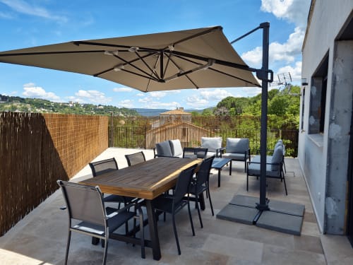 Belvedere apartment terrace at Smooth Luberon with dining table, lounge seating, and mountain views