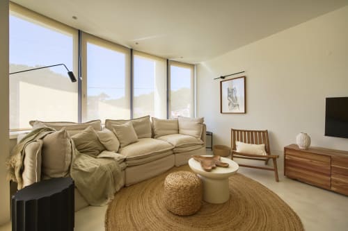 Modern living room in Casa Redonda apartment, Aroeira with beige sofa, wooden furniture, large windows and pool view