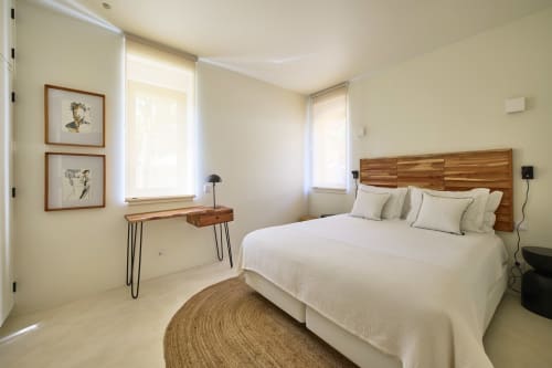 Bright modern bedroom at Casa Redonda in Aroeira with wooden bed, desk, natural light, and neutral décor