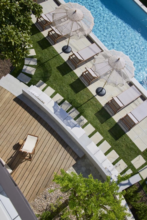 Aerial view of Casa Redonda villa pool area with loungers, umbrellas, and manicured lawn at Aroeira resort