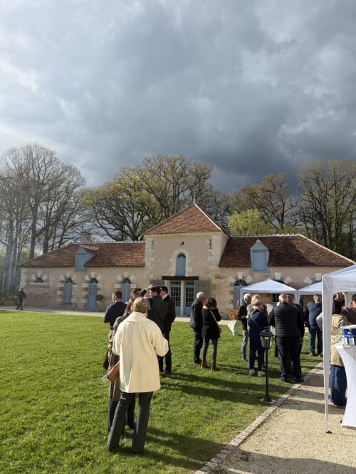 Rassemblement extérieur au gîte Cloffy à Nouans-les-Fontaines avec chapelle en pierre et tente blanche pour événement