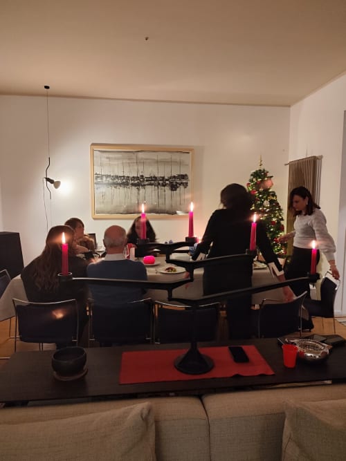 Cena festiva a Mappamondi B&B a Venezia con ospiti attorno a tavolo illuminato da candele e decorazioni natalizie