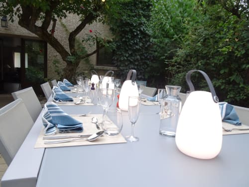 Elegant outdoor dining table at La Méridienne B&B in Venterol with place settings, glassware, and modern lighting under
