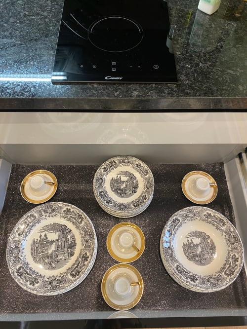 Elegant dinnerware set with gold-rimmed cups and decorative plates in Sevilla suite