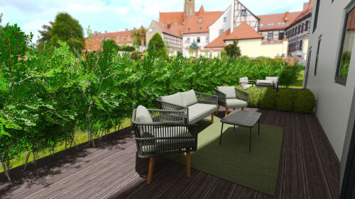 Terrasse lounge des 3 Volcans B&B Clermont-Ferrand avec sièges, haies et vues sur l'architecture médiévale