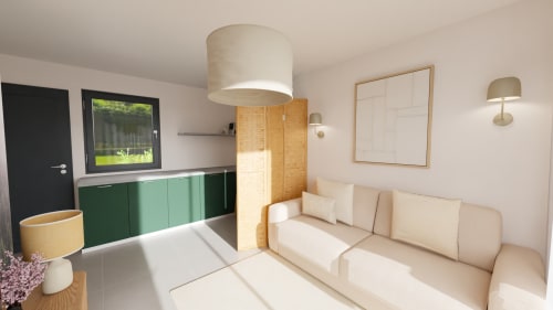 Chambre élégante aux Trois Volcans avec canapé crème, mobilier vert et lumière naturelle
