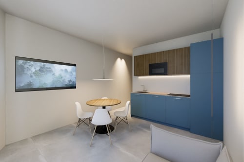 Moderno monolocale alle Riviera Apartments di Pesaro con cucina blu, tavolo da pranzo e TV a parete